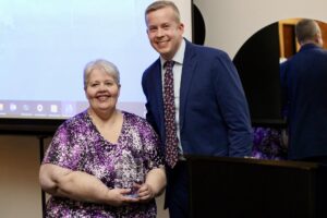 Hannibal Piecemakers Quilt Guild President accepts the Community Betterment Award